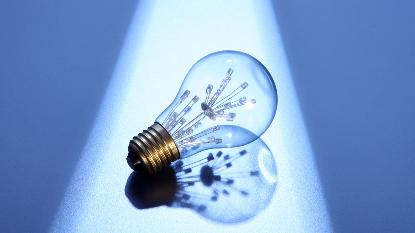 A clear LED light bulb under a spotlight, representing a brilliant business idea or a well-crafted business plan.
